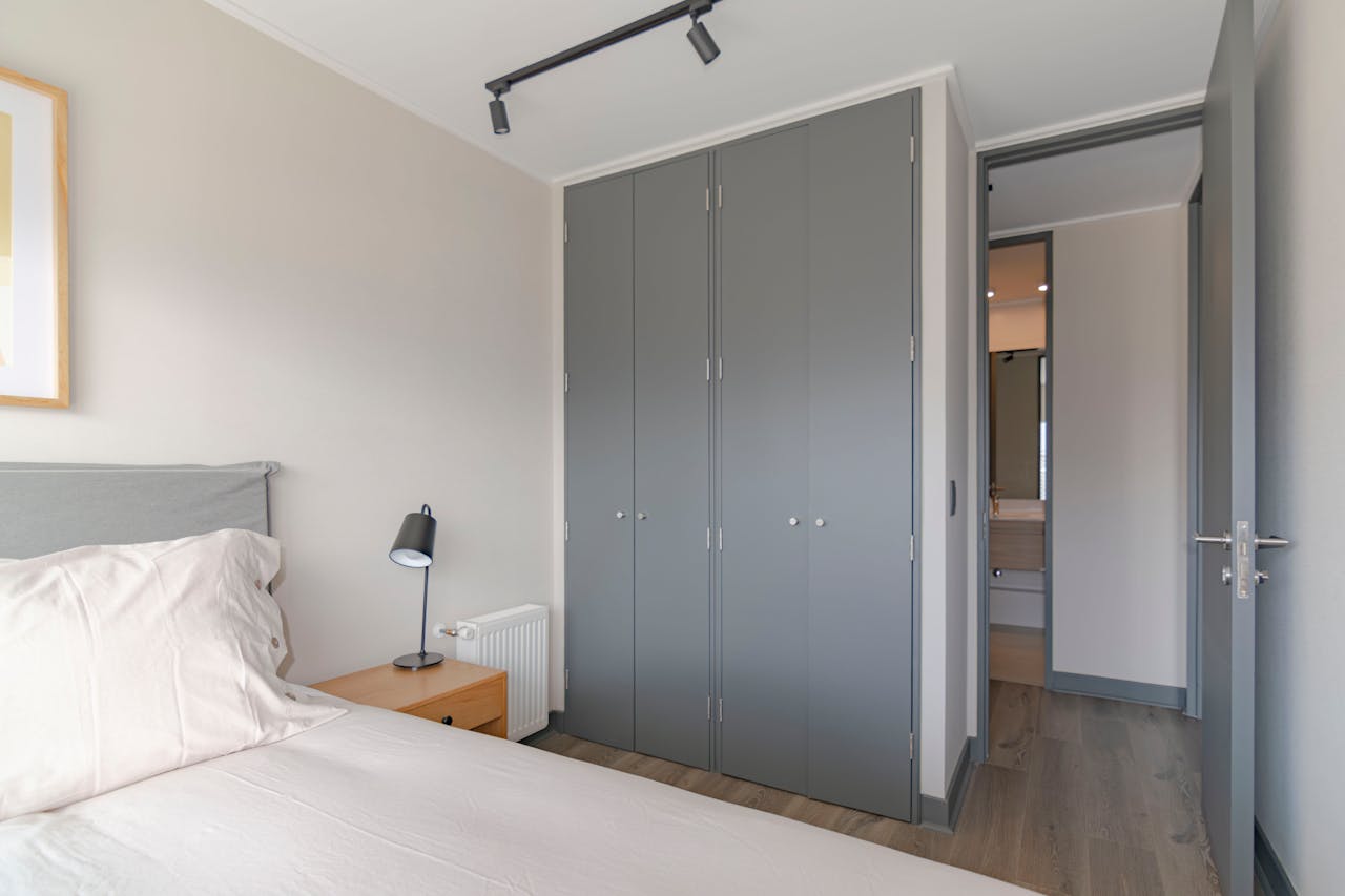 services-02 Contemporary bedroom featuring grey wardrobe and minimal decor, ideal for urban apartments.